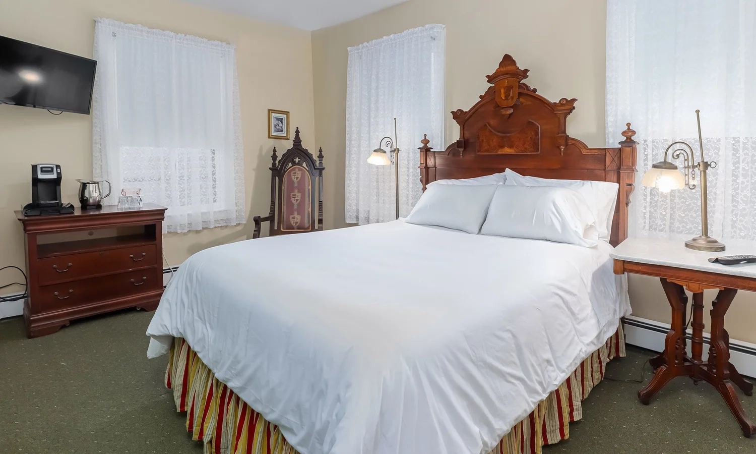 Ellen F. Page Suite bedroom with carved wood headboard bed