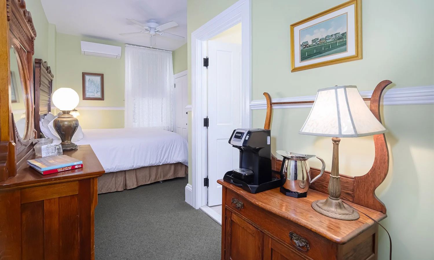 Frances' Room with pale green walls, a bed and a wood dresser