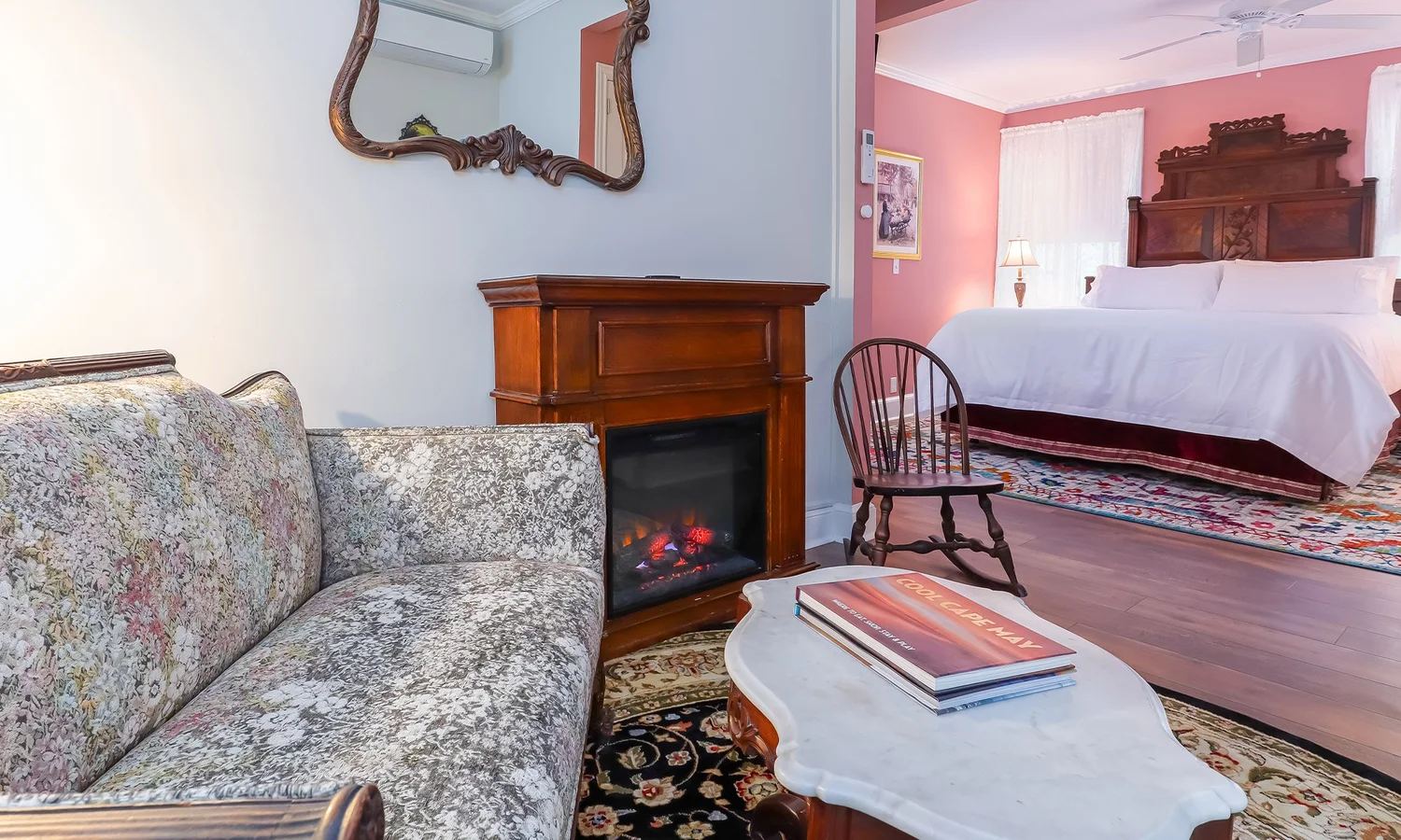 Joseph F. Page Suite sitting area with fireplace and floral sofa